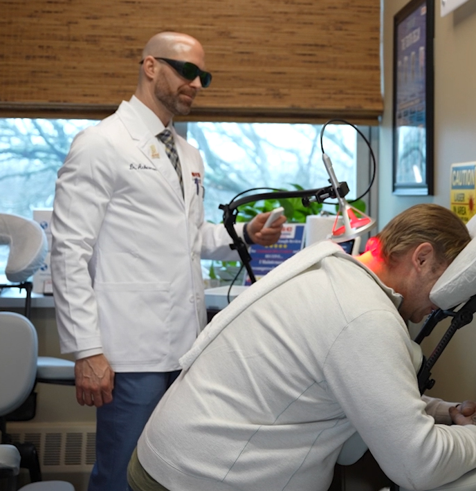 Doctor at Commack Disc Centers examining patient x-rays for spine injury