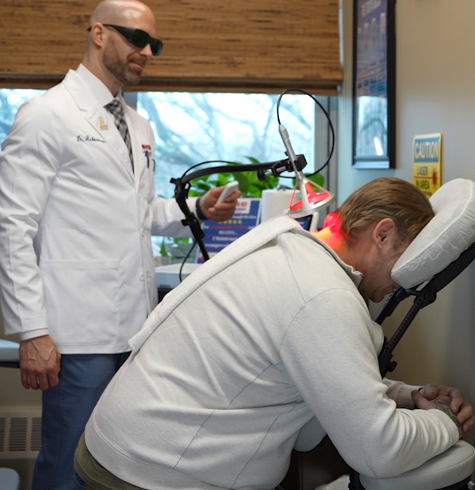 Doctor at Commack Disc Centers examining patient x-rays for spine injury